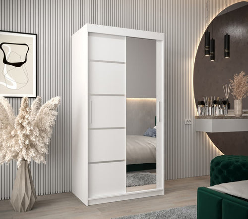 White wardrobe with sliding doors in a bedroom setting