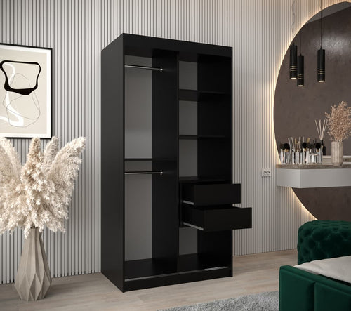 Black wardrobe with shelves and drawers in a room with decorative elements.