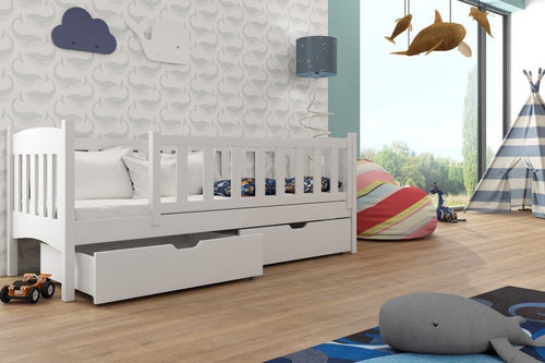Children's room with a white crib, toys, and colorful decor.