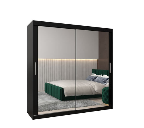 Sliding wardrobe with mirror doors showing a bedroom interior.