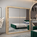 Modern bedroom with a large mirror wardrobe, green bed, and decorative elements.