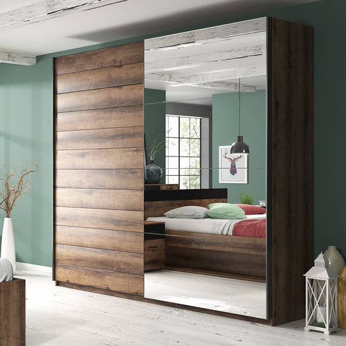 Wooden wardrobe with mirror doors in a bedroom setting