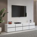 Modern living room with a white entertainment console, TV, and decorative items.