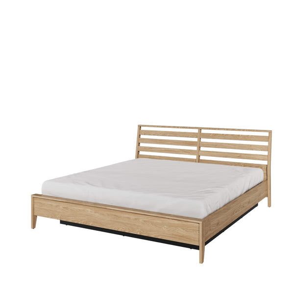 Wooden bed frame with white mattress on a white background