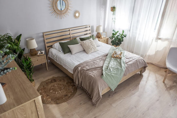 Neatly arranged bedroom with a bed, side tables, and decorative elements.