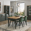 Dining room with wooden table, green chairs, and gray cabinets.