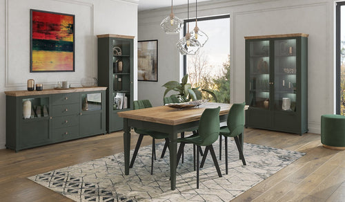 Dining room with wooden table, green chairs, and gray cabinets.
