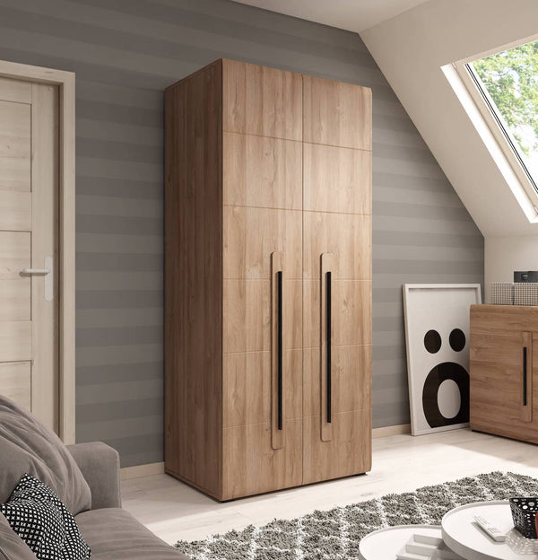 Wooden wardrobe in a room with gray walls and a skylight.