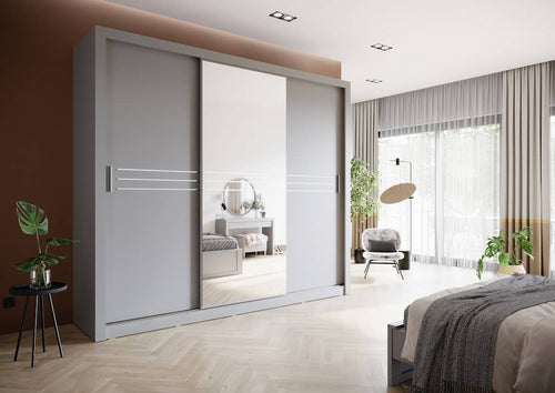 Modern bedroom with a large gray wardrobe with sliding doors, bed, and decor.