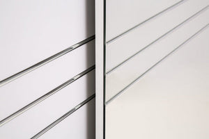 Close-up of a metallic railing with horizontal bars on a white background