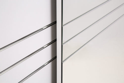 Close-up of a metallic railing with horizontal bars on a white background