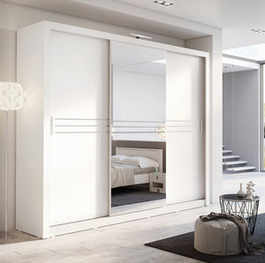 Modern white wardrobe with sliding doors in a bedroom setting