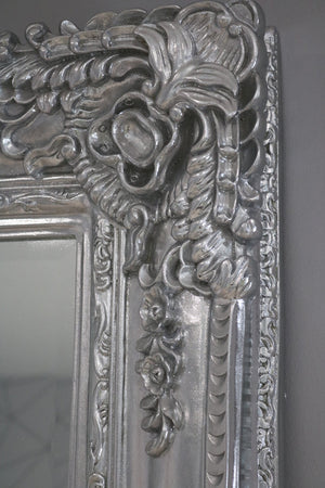 Decorative silver mirror with intricate floral patterns