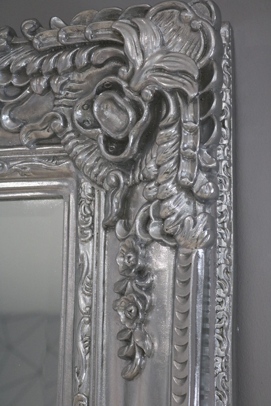 Decorative silver mirror with intricate floral patterns
