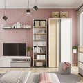 Modern living room with pink walls, white furniture, and decorative items.
