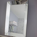 Decorative mirror with a decorative frame on a gray wall