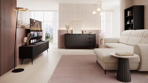 Modern living room with a beige sofa, coffee table, and television.