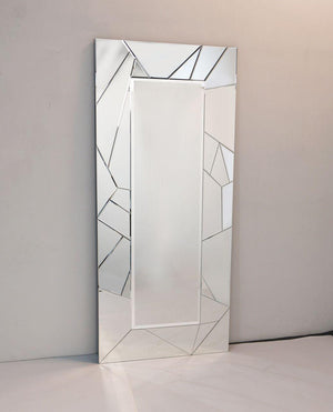 Rectangular mirror with geometric frame on a plain wall