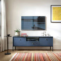 Modern living room with a blue entertainment console, TV, and decorative items.