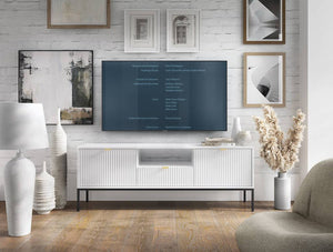 Living room with a television displaying a menu on a white wall with framed pictures.