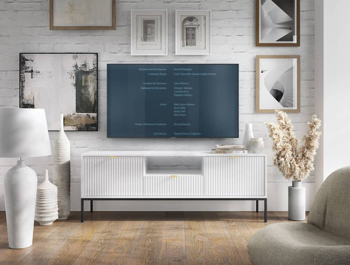 Living room with a television displaying a menu on a white wall with framed pictures.