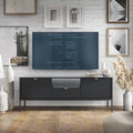 Modern living room with a television on a black entertainment console, surrounded by decorative items.