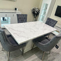 Dining room with a marble table and gray chairs in a modern kitchen setting.