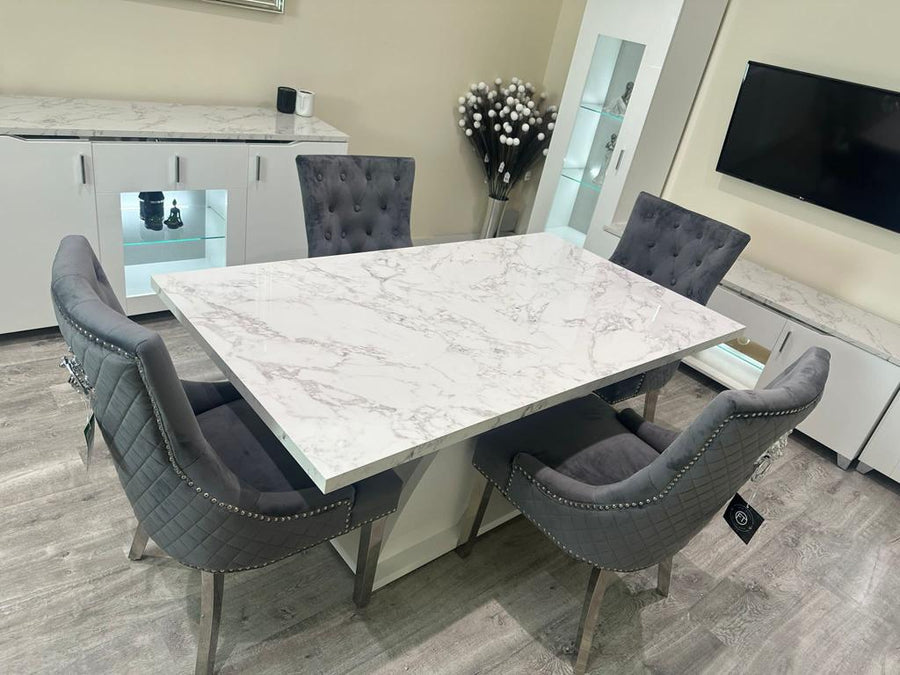 Dining room with a marble table and gray chairs in a modern kitchen setting.