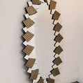 Decorative mirror with wavy, layered design on a plain background