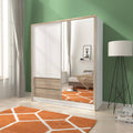 Modern bedroom with a mirrored wardrobe, bed, and lamp.