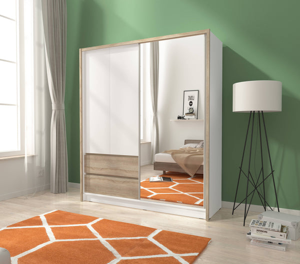 Modern bedroom with a mirrored wardrobe, bed, and lamp.