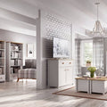 Modern living room with white furniture, bookshelves, and decor.