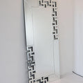 Decorative mirror with geometric frame on a white background