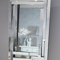 Decorative mirror with geometric design on a gray wall