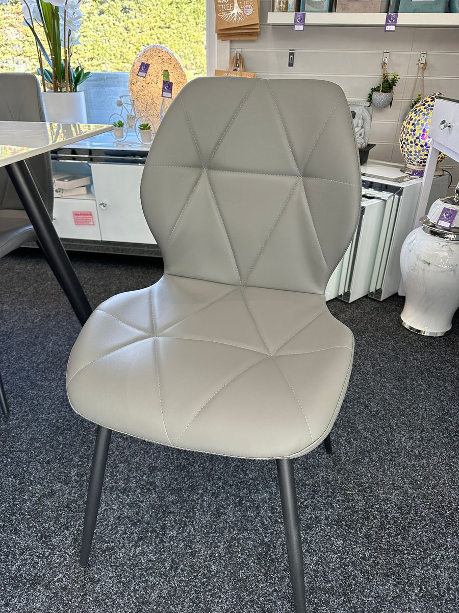 White chair with geometric pattern in a room setting