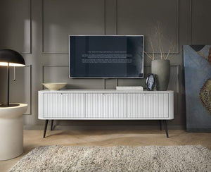 Modern living room with a white entertainment console, TV, and decorative items.