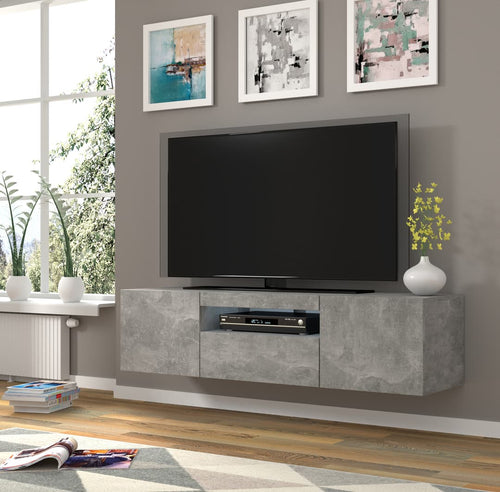 Modern living room with a TV on a concrete-style entertainment console, framed art on the wall, and decorative elements.