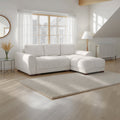 White sectional sofa in a bright living room with large windows.