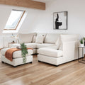 White sectional sofa in a modern living room with wooden floor and skylight.