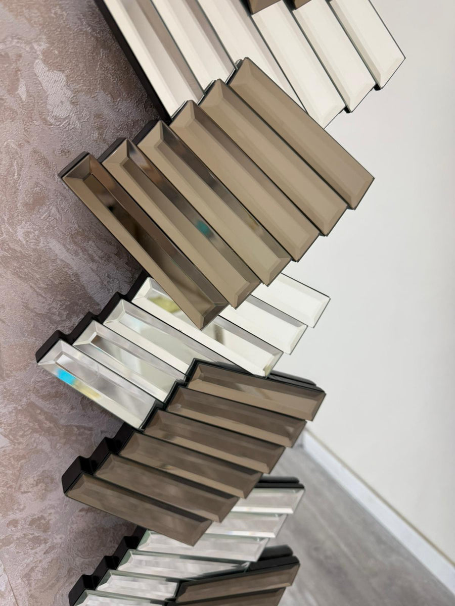 Decorative wall mirror with a geometric design on a plain background