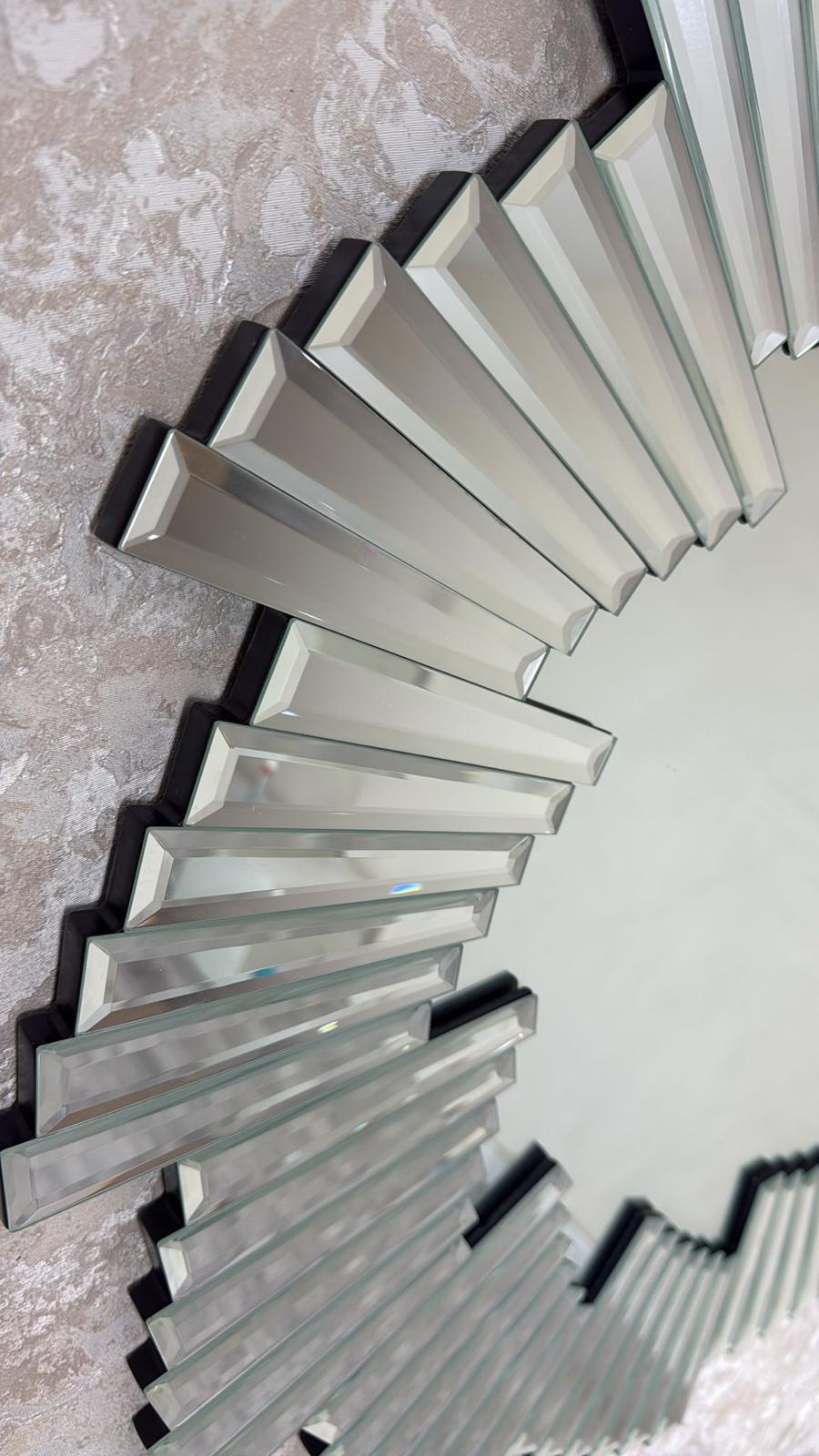 Decorative wall mirror with a unique design on a textured wall.