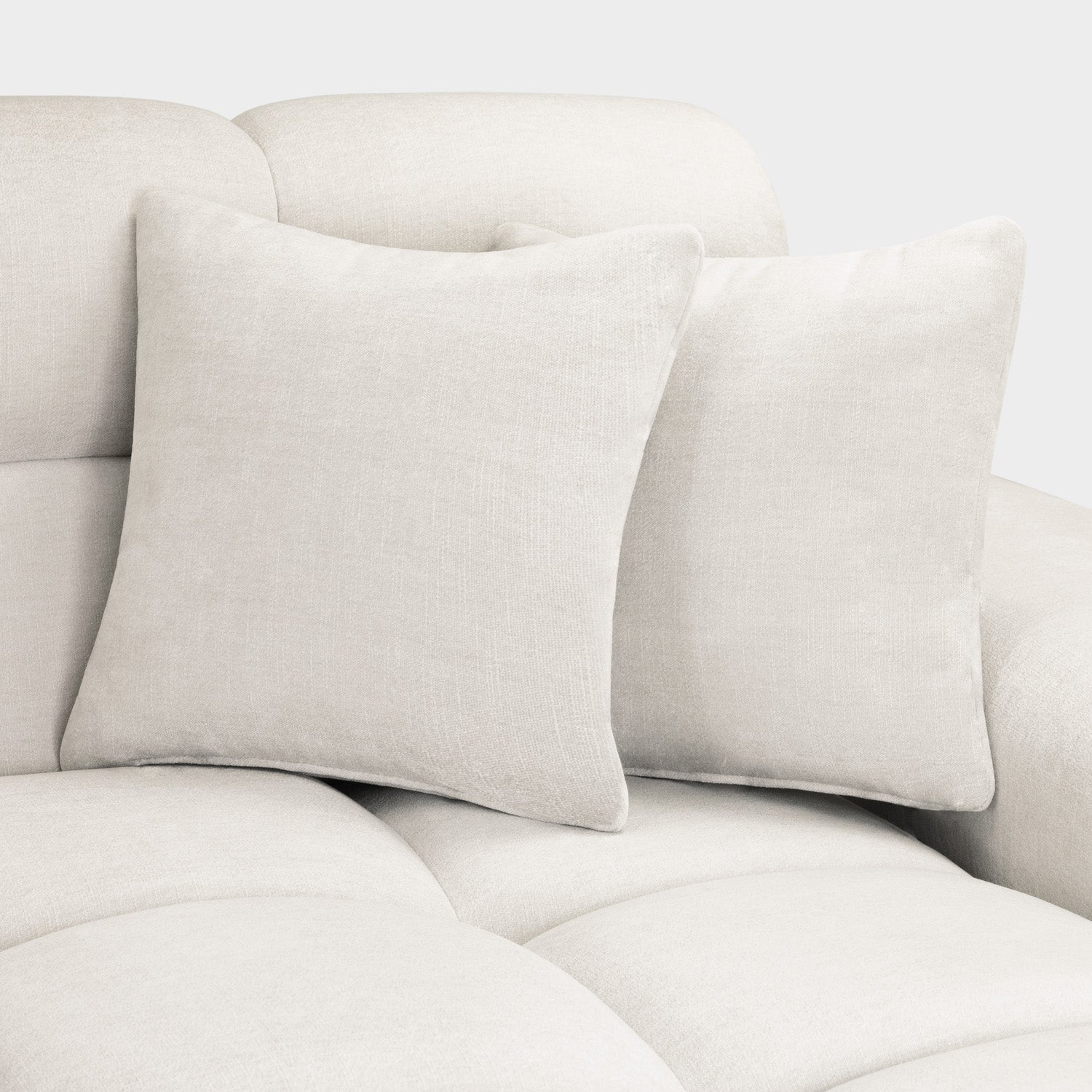 Beige sofa with two matching cushions on a light gray background