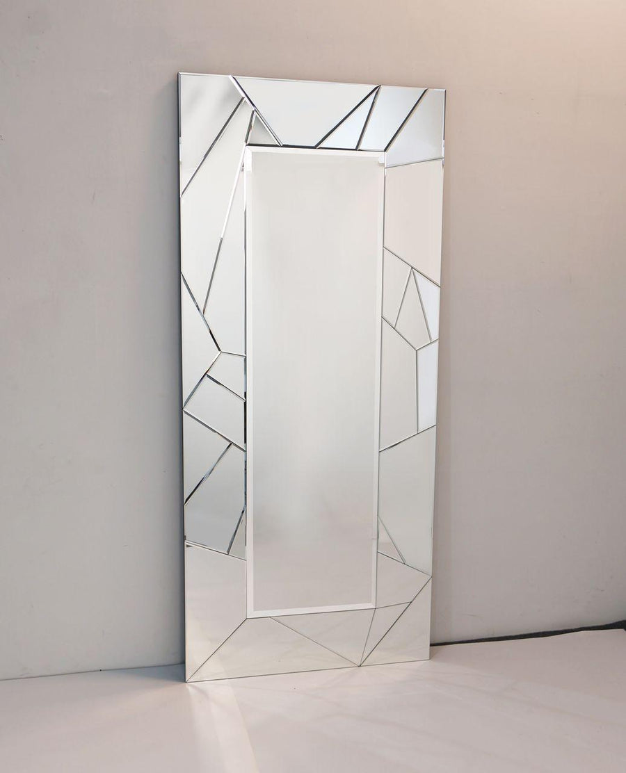 Rectangular mirror with geometric frame on a plain wall