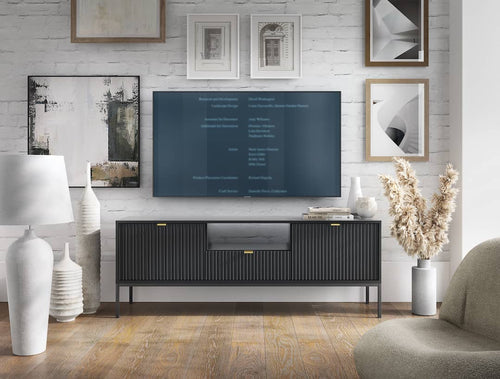 Modern living room with a television on a black entertainment console, surrounded by decorative items.