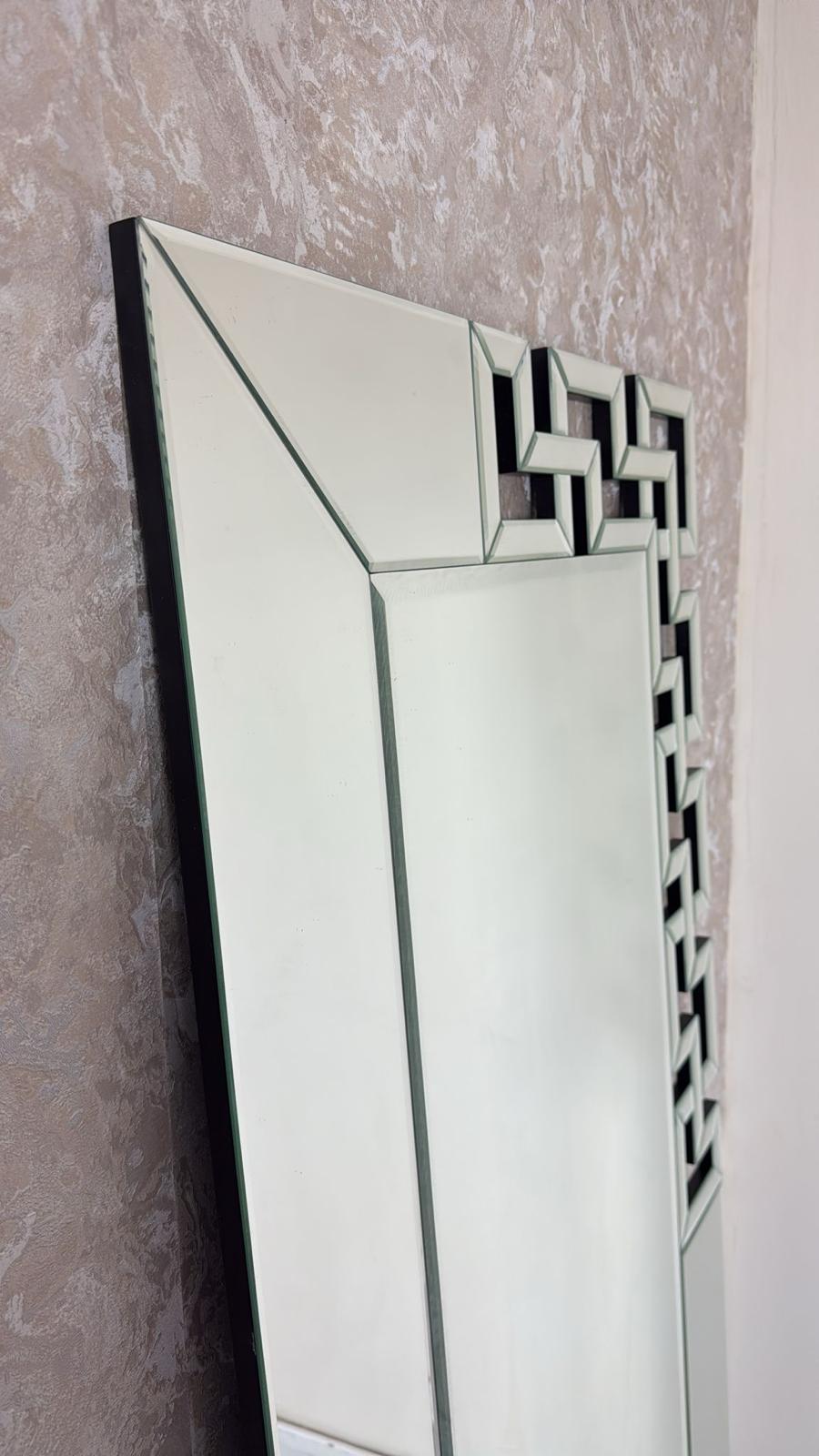 Decorative mirror with geometric frame on a textured wall